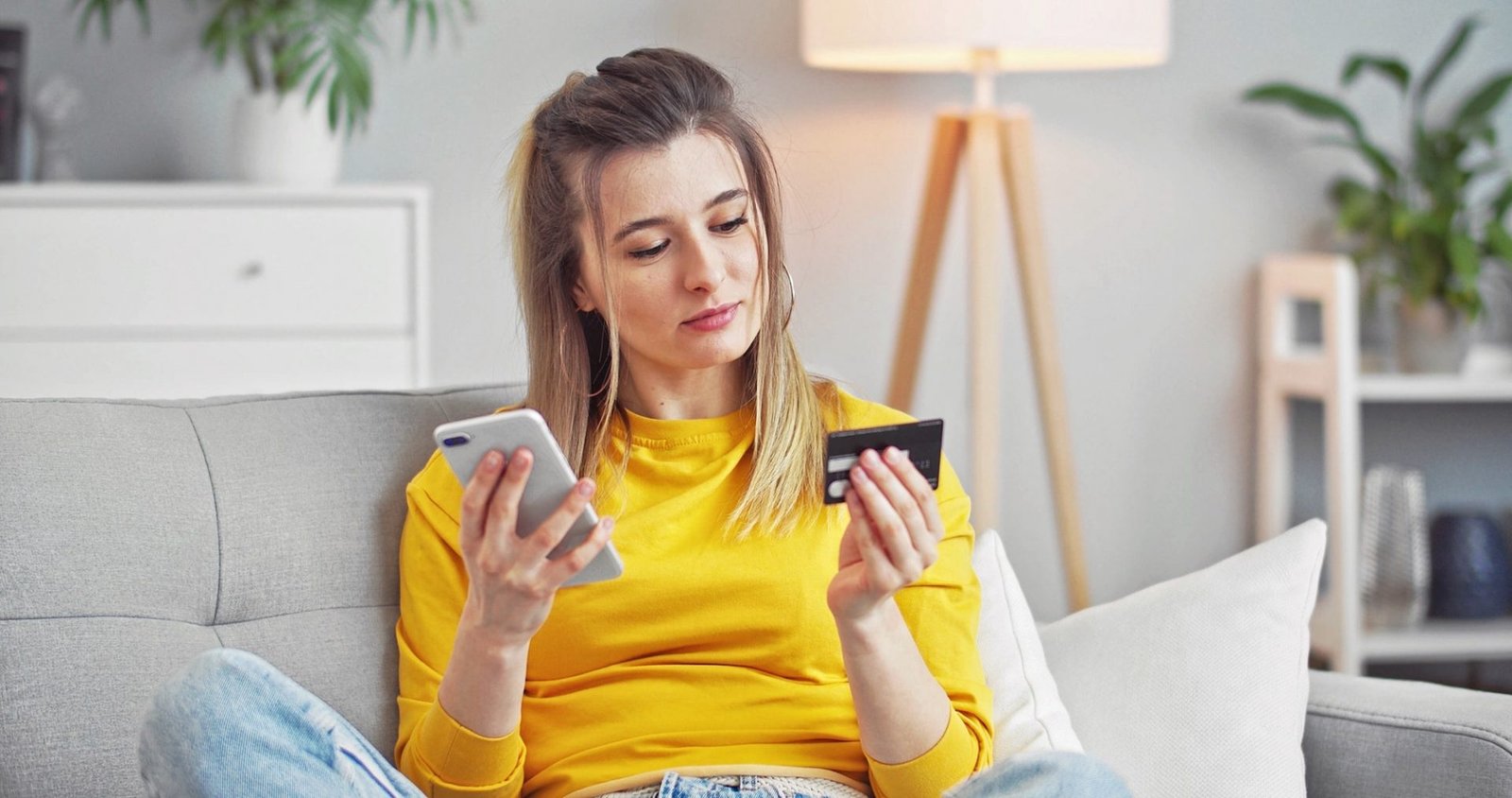 Young woman using smartphone and credit card shopping ecommerce